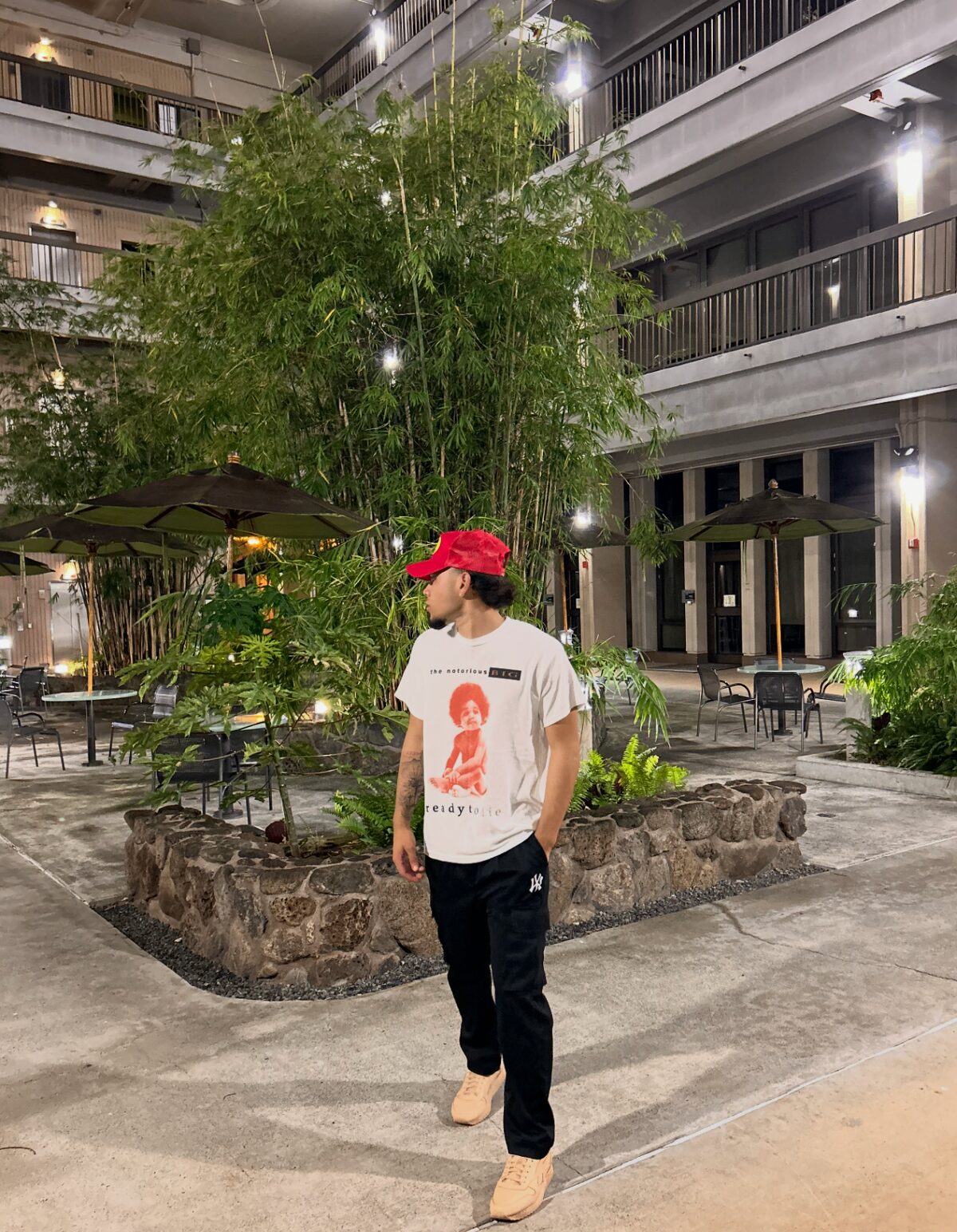 Portrait of Duke Paoa in a courtyard with bamboo